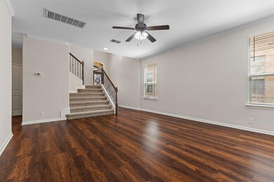 Unfurnished living room with stairs, dark wood fi