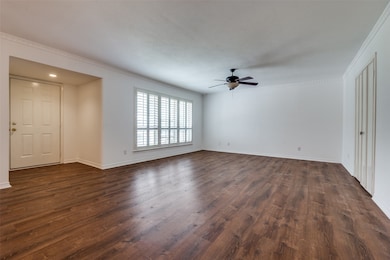 Unfurnished living room with a ceiling fan, and crown molding