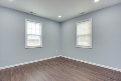 Spare room featuring baseboards, visible vents, an