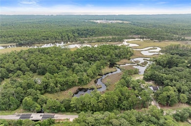 Aerial view of property's location with a nearby body of water