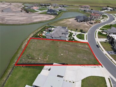 Aerial perspective of suburban area with a large body of water and property boundaries highlighted