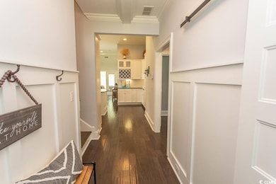 Hall with ornamental molding, dark wood-style floo