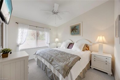 Bedroom with light colored carpet and a ceiling fan