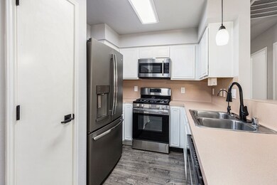 Kitchen boasts crisp white cabinets and stainless appliances which stay with the home!