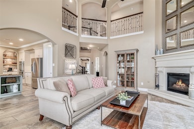 With beauty at every turn, this luxurious home has everything you need. Looking back toward the front of the home, notice the detail in the banister above. The family room opens to a glorious kitchen!