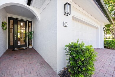 Property entrance with a garage and stucco siding