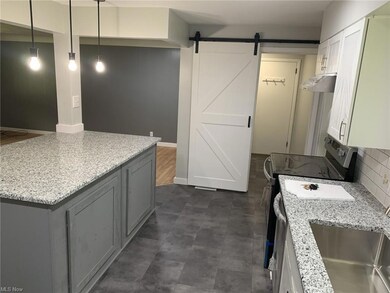 Kitchen featuring hanging light fixtures, backspla