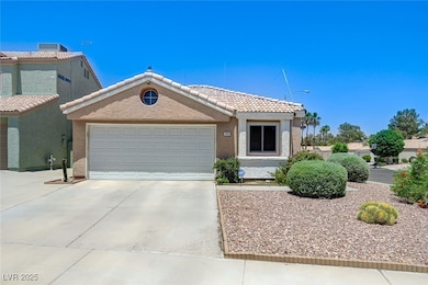 View of front of house featuring driveway, an atta