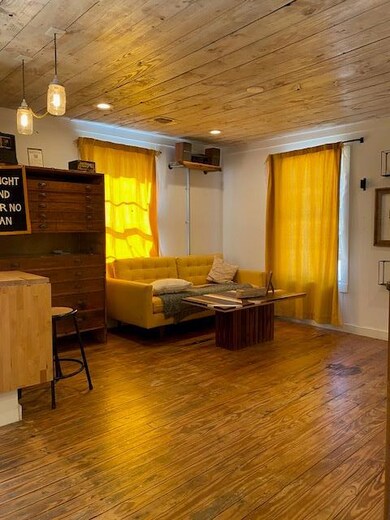 Living room with wooden ceiling, hardwood / wood-