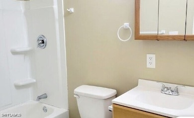 Bathroom featuring vanity, toilet, and shower / tu