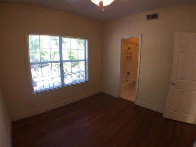 Empty room with baseboards, a ceiling fan, dark w