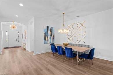 Dining area with baseboards, a notable chandelier,