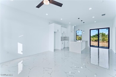 Unfurnished living room featuring ceiling fan