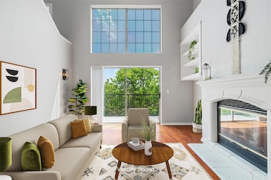 Living room with wood finished floors, a towering