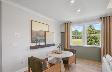 Model RepresentationDining room with light LVP finished floors, baseboards, recessed lighting, and molding