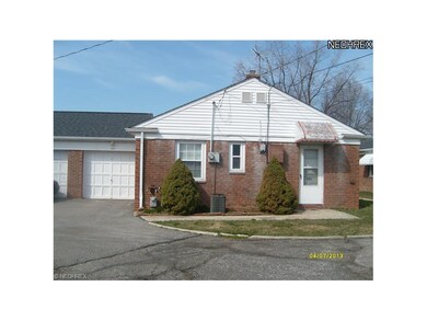 REAR OF CONDO WITH ONE CAR ATTACHED GARAGE