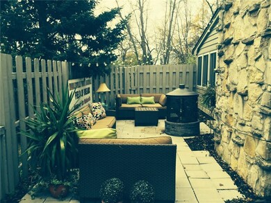 Enclosed patio area has plenty of room for multiple seating pieces, an island grill (not shown this photo) and a firepit.