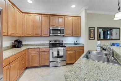 Kitchen featuring light stone countertops, stainle