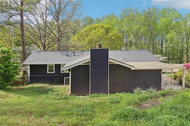 Rear view of house featuring a shingled roof, cent