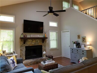 This view of the Living Room shows the staircase that leads to the upper level loft area. This space has great light and energy!
