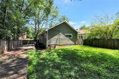 Rear view of property featuring a fenced backyard and crawl space