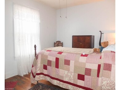 Bedroom 1 with wood flooring.