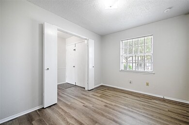 1st secondary bedroom with a textured ceiling, a c