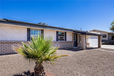 View of front of property with a garage, stucco si