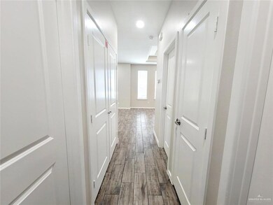 Hall featuring wood finish floors and baseboards