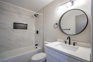 Full bath featuring a textured wall,  shower combi