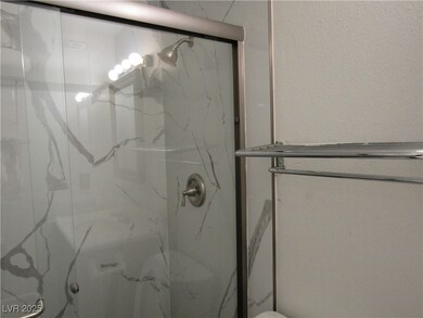 Bathroom with a marble finish shower