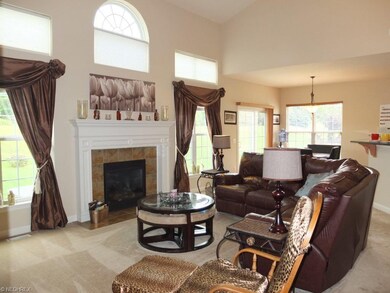 2 story great room with fireplace is open to the k