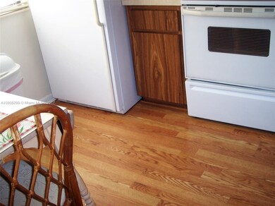 WOOD LAMINATE FLOORING IN KITCHEN AND ENTRANCEWAY.