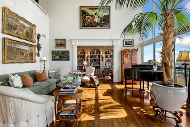Living area featuring wood finished floors and a high ceiling