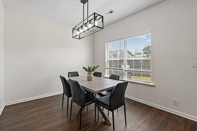 Inviting dining room with a new chandelier and views into the backyard.