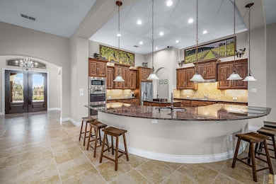 Kitchen with a breakfast bar, a sink, a towering 