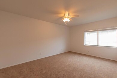 Spare room featuring baseboards, a ceiling fan, a