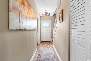 Doorway to outside featuring wood-type flooring