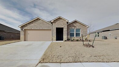 View of front of home with cooling unit and a gara