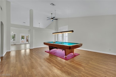 Rec room with high vaulted ceiling, billiards, lig