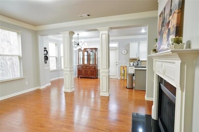 Living area featuring crown molding, a fireplace w