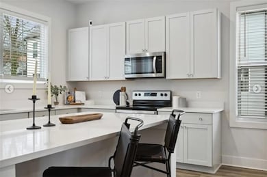 Kitchen with a breakfast bar area, hardwood / wood