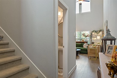 Stairs featuring ceiling fan, wood-type flooring, 