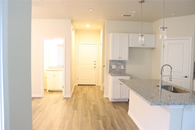 Kitchen featuring a sink, light wood-style floors