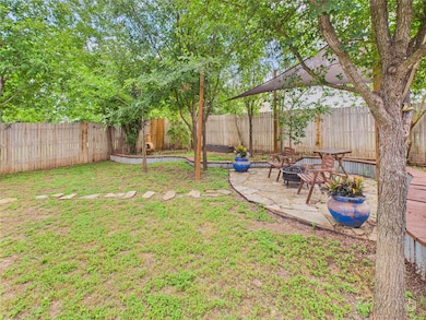 Fenced backyard featuring an outdoor fire pit and