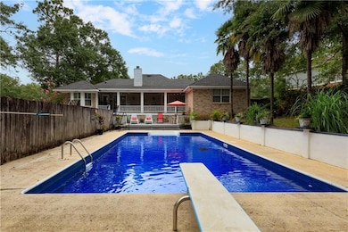 View of swimming pool with a fenced in pool and fe