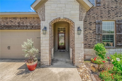 Entrance to property with brick siding, stone sidi