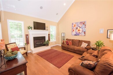 Living Room with gas logs fireplace and vaulted ce