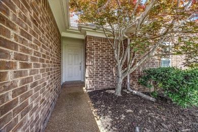 Entrance to property featuring brick siding