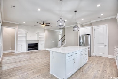 Kitchen featuring hanging light fixtures, a center